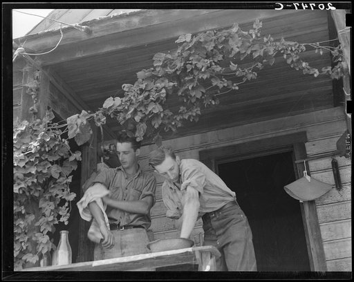 Oregon. Independence, Polk County. Hop farmer's sons, washing for noon meal on back porch. They supervise the migratory workers in the field and tend to the weighing of hops