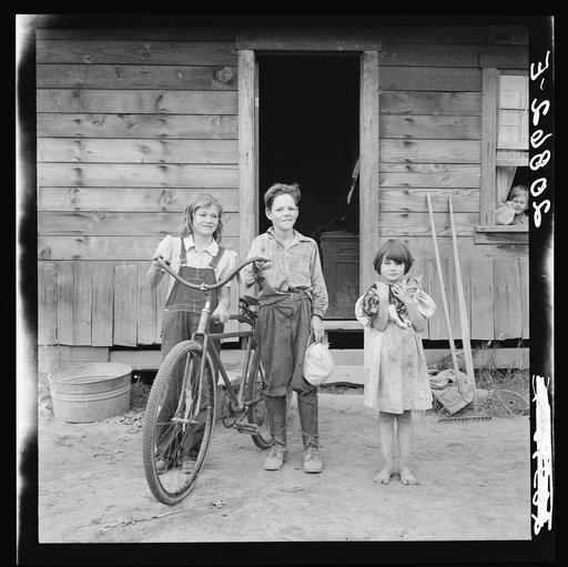 Three of the four Arnold children. The oldest boy earned the money to buy his bicycle. Western Washington, Thurston County, Michigan Hill. See general Caption number 36