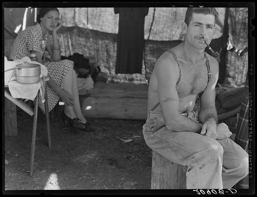 Unemployed lumber worker goes with his wife to the bean harvest. Note social security number tattooed on his arm. Oregon. See general caption number 46