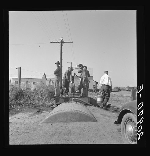 Town pump of Tulelake at railroad yard. Tulelake, Siskiyou County, California. Over 1500 people depend on hauled water for drinking the year round. During potato harvest, this pump also serves the migratory pickers. General caption number 44