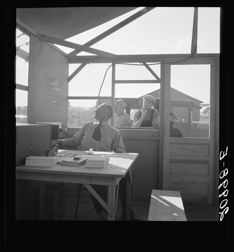 Manager of mobile unit (FSA - Farm Security Administration) on day camp opened, in registration tent. Merrill, Klamath County, Oregon. General caption number 62-1
