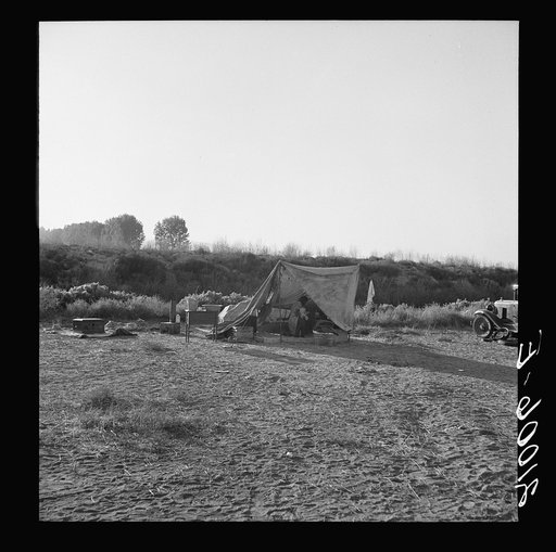 Young family on ditch bank, waiting to enter farm family labor camp (FSA - Farm Security Administration). They came from North Dakota, have young baby. "Two years in this kind of work." Merrill, Klamath County, Oregon