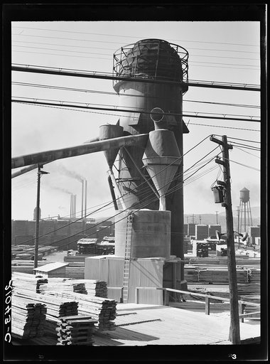 Untitled photo, possibly related to: Lumber burner and stacks of the Big Lakes Lumber Company, which produces box shook for produce boxes. Klamath Falls, Oregon