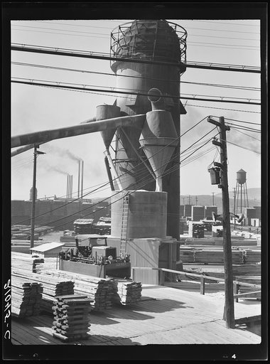 Untitled photo, possibly related to: Lumber burner and stacks of the Big Lakes Lumber Company, which produces box shook for produce boxes. Klamath Falls, Oregon