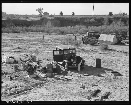 Camped on the flat. Family with five children, left their home in Texas in September 1938. They picked their way across the country in Texas and Arizona cotton. They had just entered California the night before. Near Holtville, Imperial County, California
