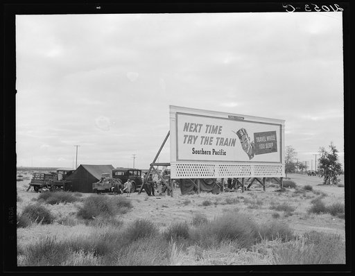 Camped in the rain behind billboard: three families, fourteen children. On U.S. 99. Near Famosa [or Vamosa], Kern County, California