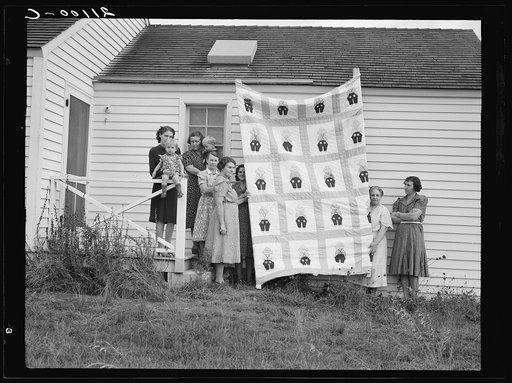 Untitled photo, possibly related to: Farm women of the "Helping Hand" club display a pieced quilt which they are making for the benefit of one of their numbers. Near West Carlton, Yamhill County, Oregon. General caption number 58-11
