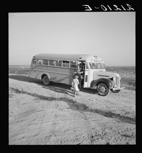 Dead Ox Flat. Children get into school bus on a fall morning. Malheur County, Oregon. General caption number 67-1V