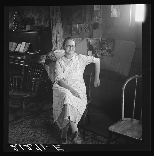 Mrs. Hull, in one room basement dugout home, late afternoon. Dead Ox Flat, Malheur County, Oregon. General caption number 67-111