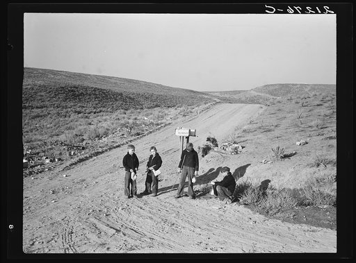 Boys wait for school bus in the morning. Malheur County, Oregon. See general caption number 67-1V