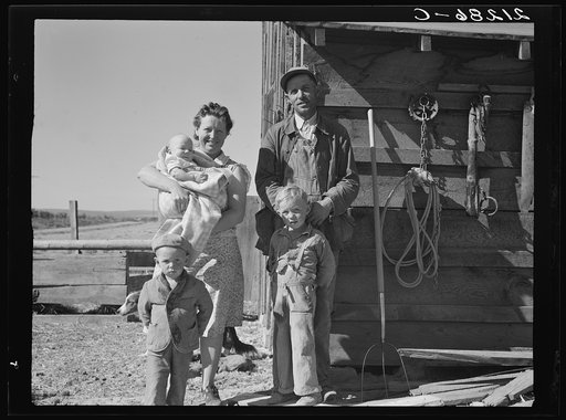 The Schroeder family on their new farm. When they first came two years ago lived in shed shown. Dead Ox Flat, Malheur County, Oregon