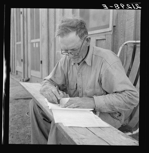 Oklahoma farmer, now living in Cow Hollow, is a FSA (Farm Security Administration) borrower. Seen here signing his chattel mortgage. Malheur County, Oregon