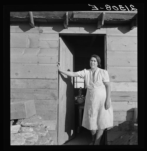Mrs. Dougherty in doorway of basement house. Warm Springs, Malheur County, Oregon