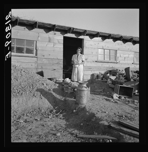 Mrs. Dougherty in doorway of basement house. Warm Springs, Malheur County, Oregon