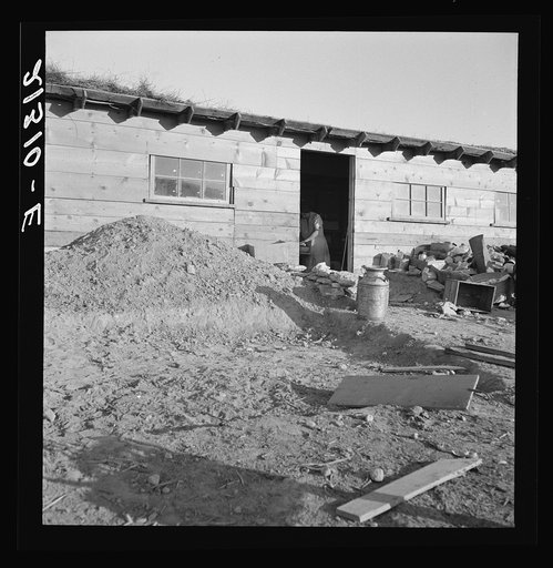 Untitled photo, possibly related to: Mrs. Dougherty in doorway of basement house. Warm Springs, Malheur County, Oregon