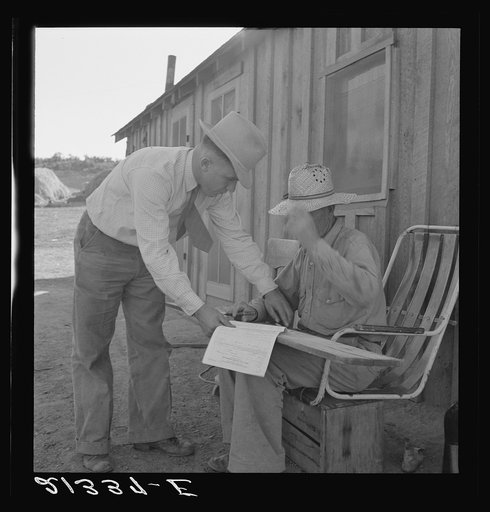 Untitled photo, possibly related to: Oklahoma farmer, now living in Cow Hollow, is a FSA (Farm Security Administration) borrower. Seen here signing his chattel mortgage. Malheur County, Oregon