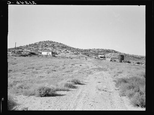 The Niccum farm, seen from road against sage brush hills. Malheur County, Oregon