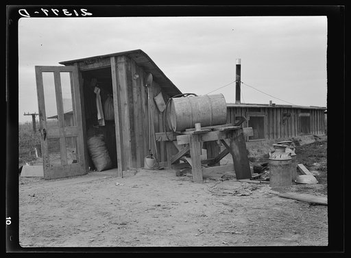 Untitled photo, possibly related to: Mr. and Mrs. Wardlow at entrance to their dugout basement home. Dead Ox Flat, Malheur County, Oregon