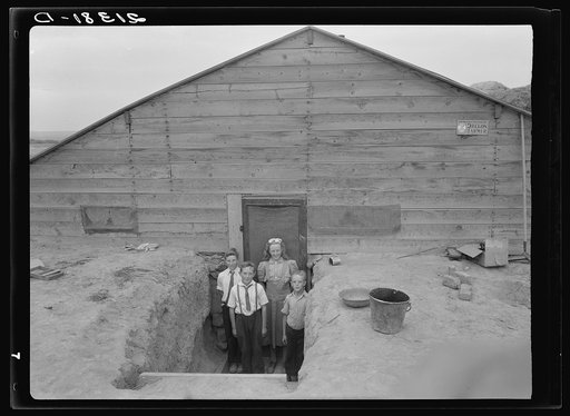 The Free children in doorway of their home in Sunday clothes. Dead Ox Flat, Malheur County, Oregon