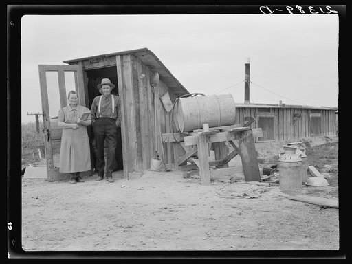 Mr. and Mrs. Wardlow at entrance to their dugout basement home. Dead Ox Flat, Malheur County, Oregon