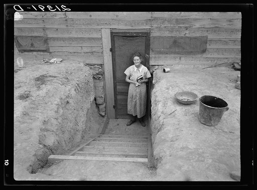 Mrs. Free in doorway of her basement dugout home. Dead Ox Flat, Malheur County, Oregon