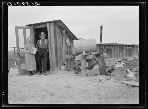 Untitled photo, possibly related to: Mr. and Mrs. Wardlow at entrance to their dugout basement home. Dead Ox Flat, Malheur County, Oregon