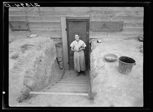 Untitled photo, possibly related to: Mrs. Free in doorway of her basement dugout home. Dead Ox Flat, Malheur County, Oregon