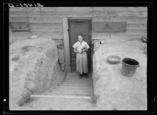 Untitled photo, possibly related to: Mrs. Free in doorway of her basement dugout home. Dead Ox Flat, Malheur County, Oregon
