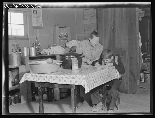 The youngest Wardlow boy copies out a recipe for his mother. Dead Ox Flat, Malheur County, Oregon