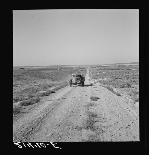 The cream truck coming down the road represents one steady element in the new settlers' income. Nyssa Heights, Malheur County, Oregon