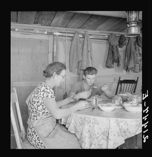 Mrs. Dazey and sixteen year old at lunch. The other children are working in neighbor's fields topping onions. Homedale district, Malheur County, Oregon
