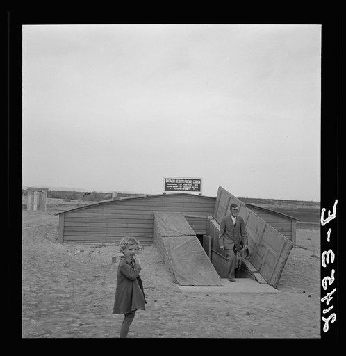 Untitled photo, possibly related to: Congregation leaving after services. Preacher in doorway. Dead Ox Flat, Malheur County, Oregon