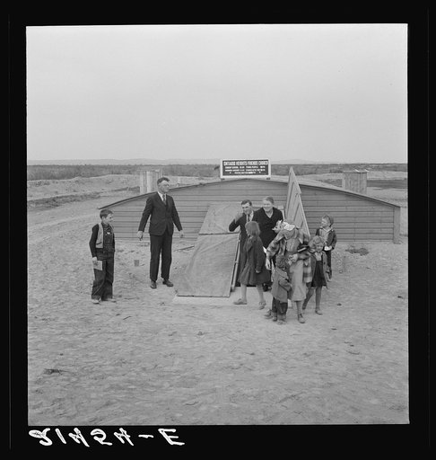 Untitled photo, possibly related to: Congregation leaving after services. Preacher in doorway. Dead Ox Flat, Malheur County, Oregon