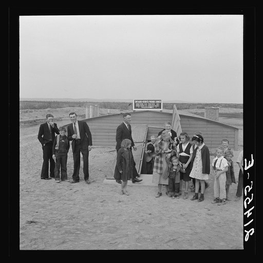 Untitled photo, possibly related to: Congregation leaving after services. Preacher in doorway. Dead Ox Flat, Malheur County, Oregon
