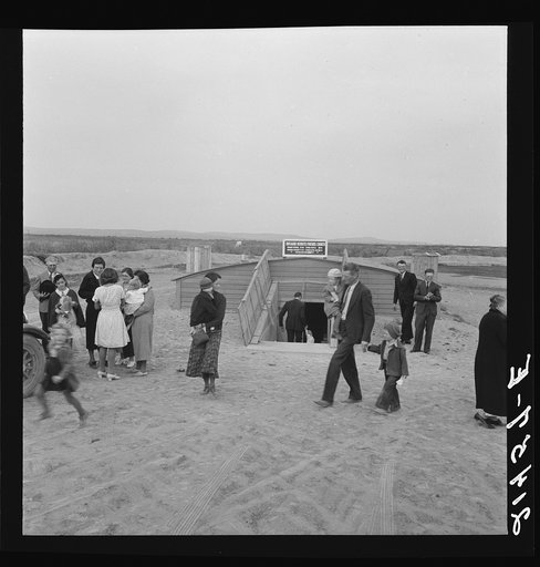 Untitled photo, possibly related to: Congregation leaving after services. Preacher in doorway. Dead Ox Flat, Malheur County, Oregon