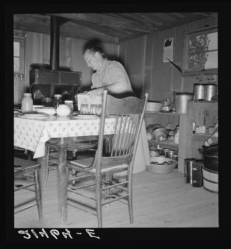 Mrs. Wardlow bakes her own bread in her dugout house. Dead Ox Flat, Malheur County, Oregon