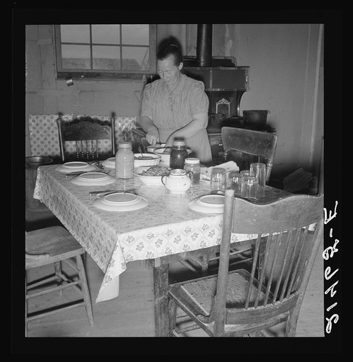 Untitled photo, possibly related to: Mrs. Wardlow bakes her own bread in her dugout house. Dead Ox Flat, Malheur County, Oregon