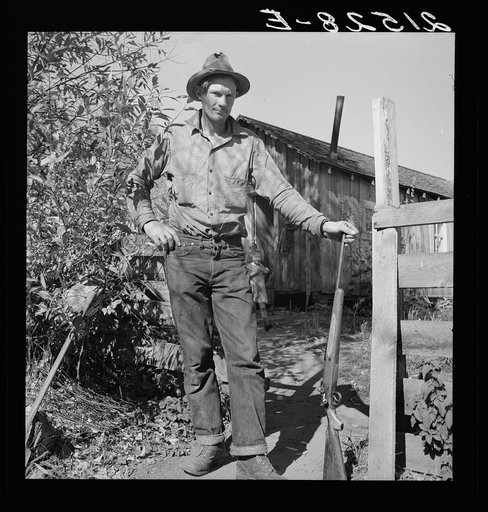Roy Carlock, member of Ola self-help sawmill co-op, in front of his new house. He is one of the best hunters in the community and keeps his larder supplied with game during the hunting season. His people have lived in the valley since it was first settled. Gem County, Idaho. General caption 48