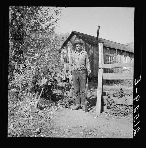 Untitled photo, possibly related to: Roy Carlock, member of Ola self-help sawmill co-op, in front of his new house. He is one of the best hunters in the community and keeps his larder supplied with game during the hunting season. His people have lived in the valley since it was first settled. Gem Co