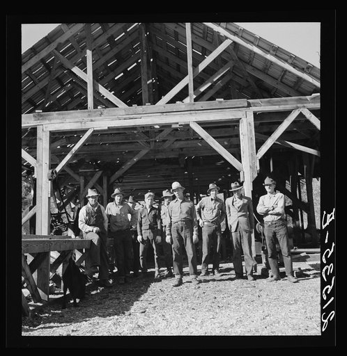 Untitled photo, possibly related to: Men working in mill. Ola self-help sawmill co-op. Gem County, Idaho. Man in rear center in black hat is FSA (Farm Security Administration) county supervisor. General caption 48