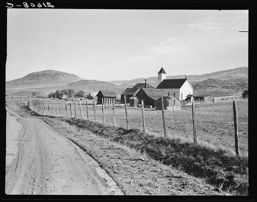 Entering Ola, Gem County, Idaho. Voting farmers in Squaw Creek Valley number 185, town population about 30. Ola self-help co-op. See general capttion 48