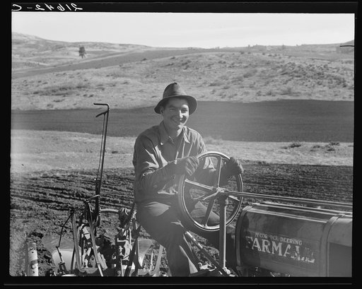 Young farmer, member of Ola self-help sawmill co-op, plowing in fall of the year. Tractor is used co-operatively. Gem County, Idaho. General caption 48
