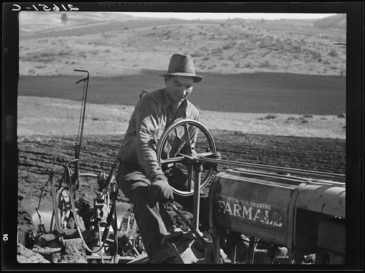 Untitled photo, possibly related to: Young Idaho farmer plowing in the fall of the year while the other members of the Ola self-help sawmill co-op are working in the sawmill. The tractor does work for five member families. Gem County, Idaho