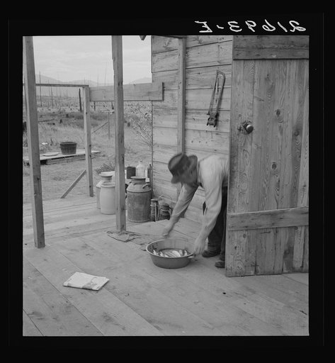 Untitled photo, possibly related to: New settler shows fish he caught this morning. He "likes it fine here." Priest River Valley, Bonner County, Idaho. See general caption 54