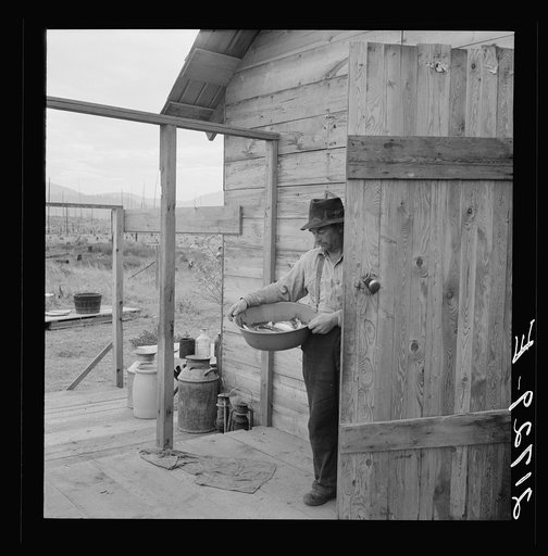 New settler shows fish he caught this morning. He "likes it fine here." Priest River Valley, Bonner County, Idaho. See general caption 54