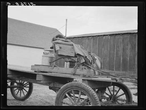 Stump farmer's wagon. Note cream can tied behind store on Saturday afternoon, approaching winter. Bonners Ferry, Idaho. See general caption 49