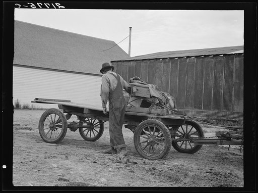 Untitled photo, possibly related to: Stump farmer's wagon. Note cream can tied behind store on Saturday afternoon, approaching winter. Bonners Ferry, Idaho. See general caption 49