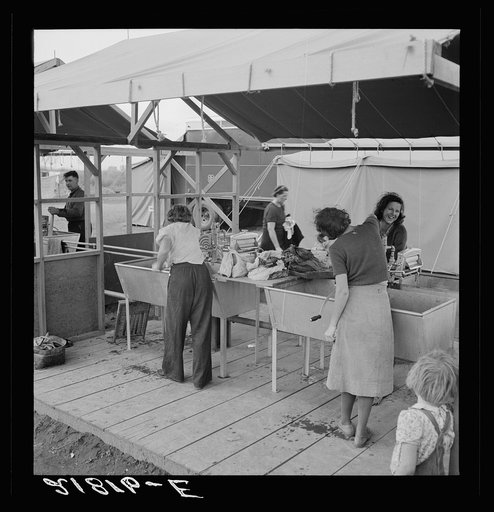 Portable laundry unit, shower unit beyond. FSA (Farm Security Administration) camp, Merrill, Oregon. See general caption 62