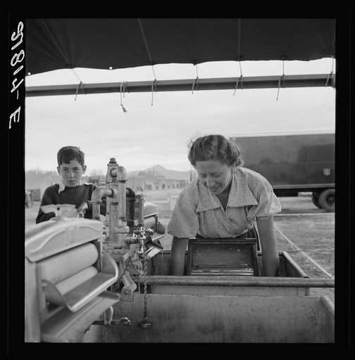 Untitled photo, possibly related to: Portable laundry unit, shower unit beyond. FSA (Farm Security Administration) camp, Merrill, Oregon. See general caption 62