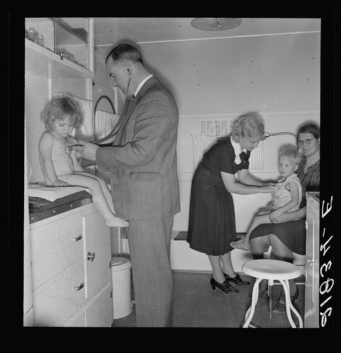 Doctor examining children in trailer clinic. FSA (Farm Security Administration) mobile camp, Klamath County, Oregon. See general caption 62